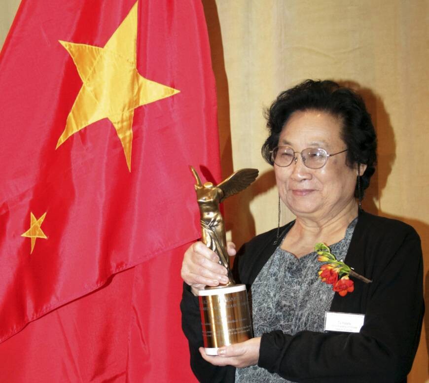 Chinese pharmacologist Tu Youyou poses with her trophy after winning the Lasker Award, a prestigious U.S. medical prize, in New York in September 2011.