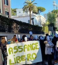 Manifestanti con maschere di Julian Assange davanti all’Ambasciata australiana di Roma (edificio bianco) durante un sit-in tenutosi in occasione della festa del Carnevale, 12 febbraio 2023.