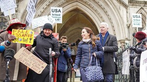Stella_Morris_congratulated_by_a_supporter_as_she_leaves_the_High_Court together with Kristinn Hfrafnsson 