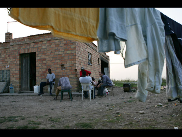 Fabrizio Gatti all'esterno di una casa abbandonata con gli immigrati schiavi